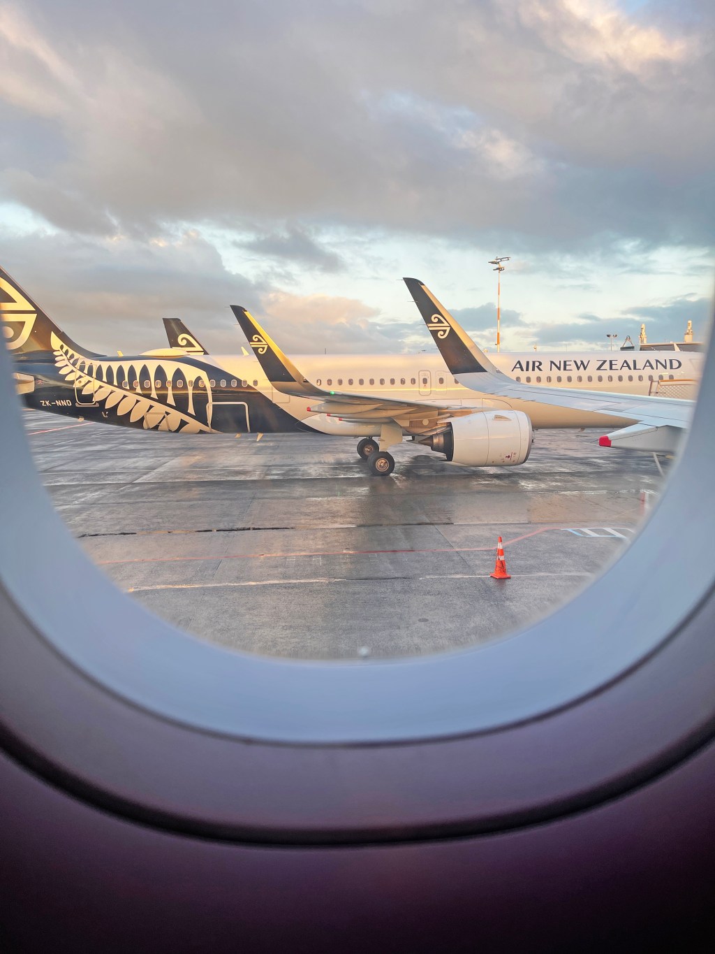 Looking out an airplane windown at the Auckland airport tarmac